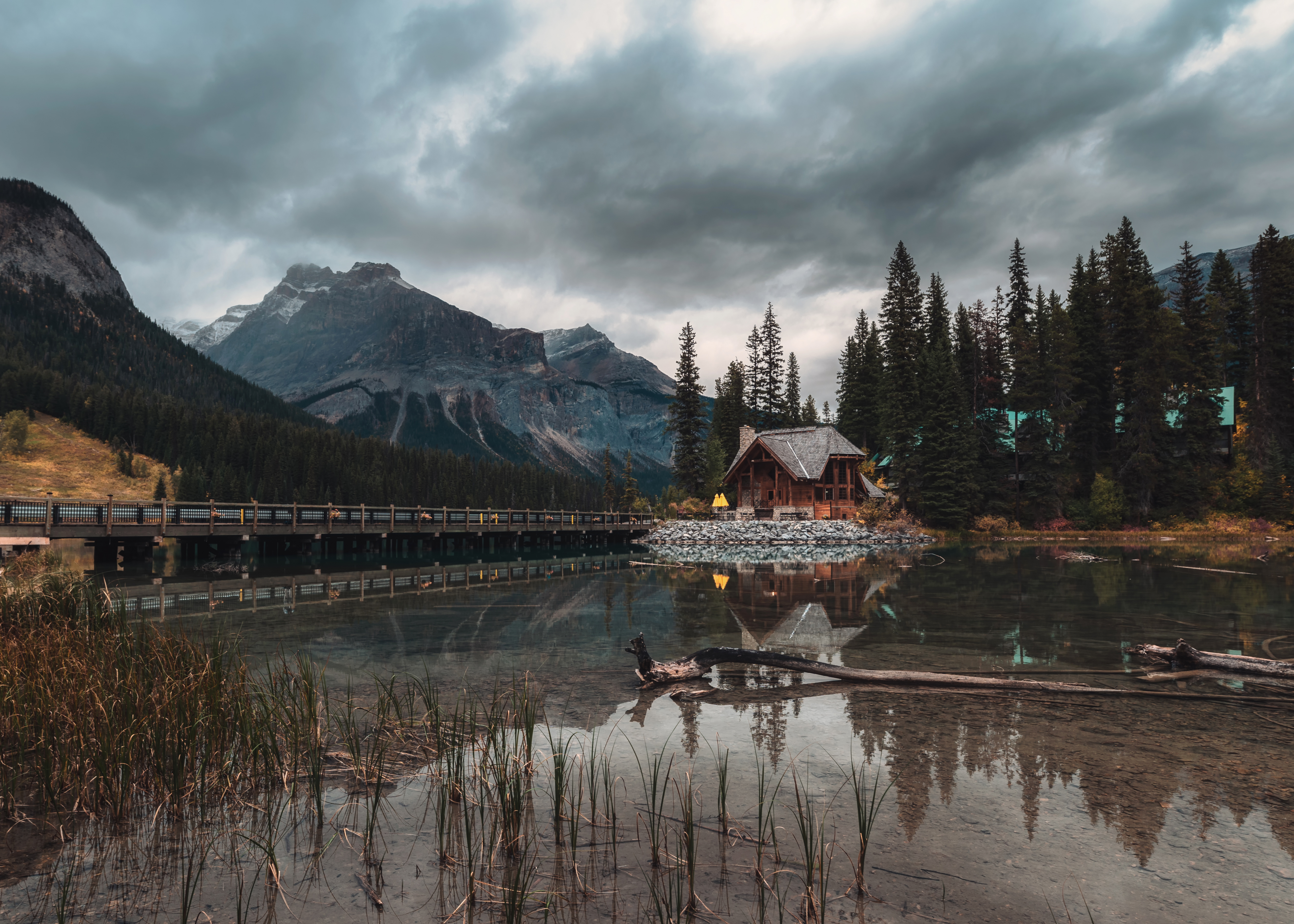 Wooden lodge reflected in a mountain lake